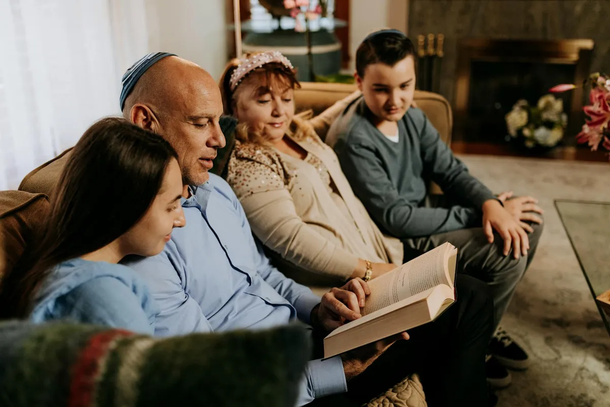 A family reading together at home in warm afternoon light